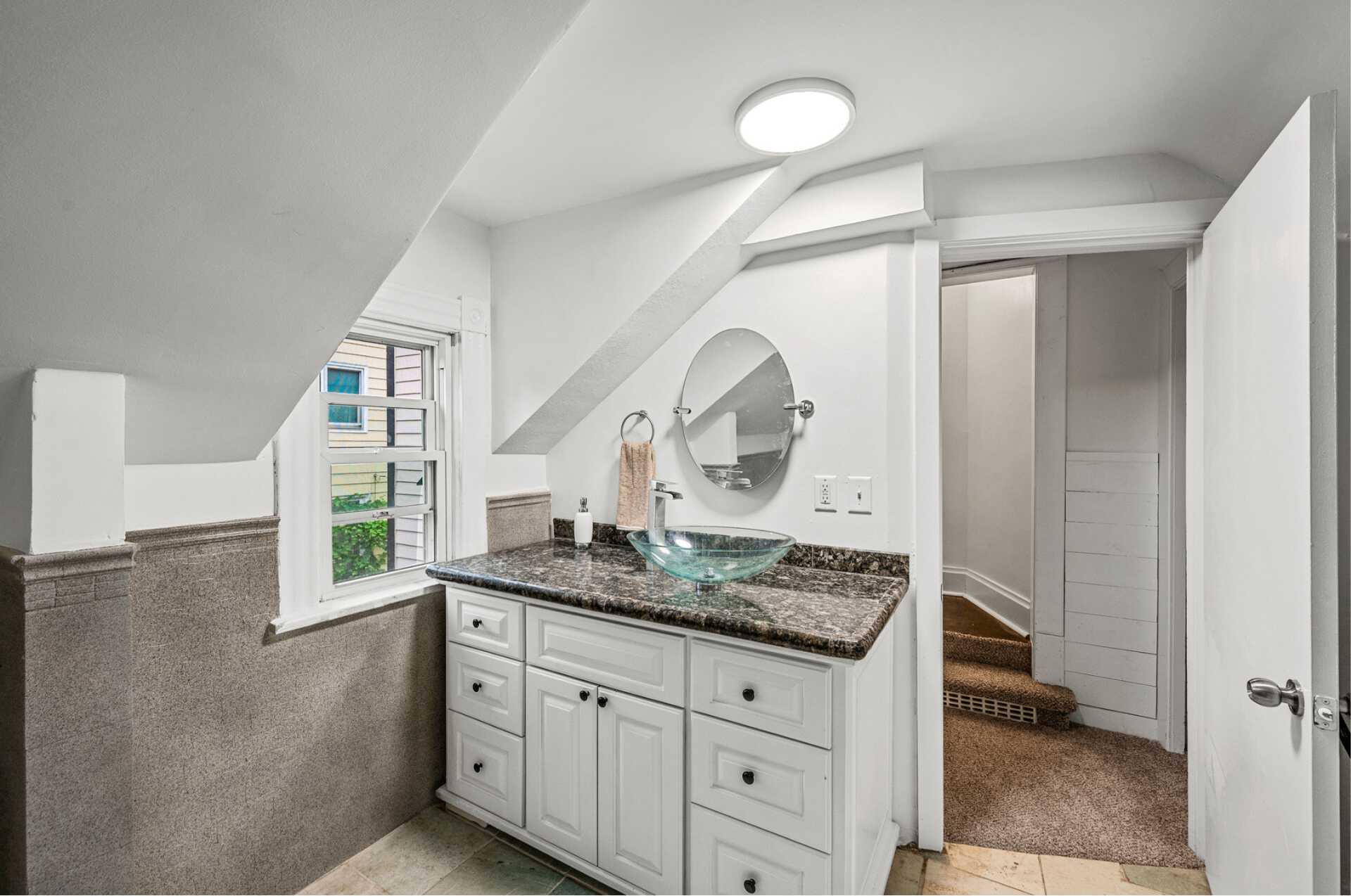 Refreshed bathroom with white tile, new vanity, and modern fixtures, after remodel